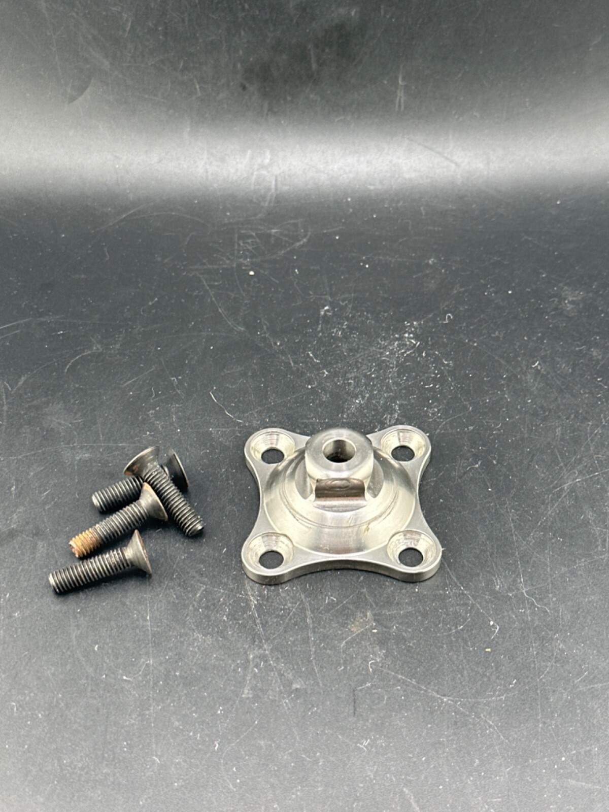 Prosthetic component adapter part. Bulldog 4 hole male pyramid plate
