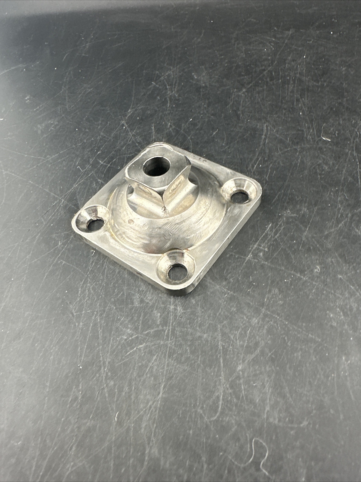Prosthetic 4 Hole Plate Adapter Component.