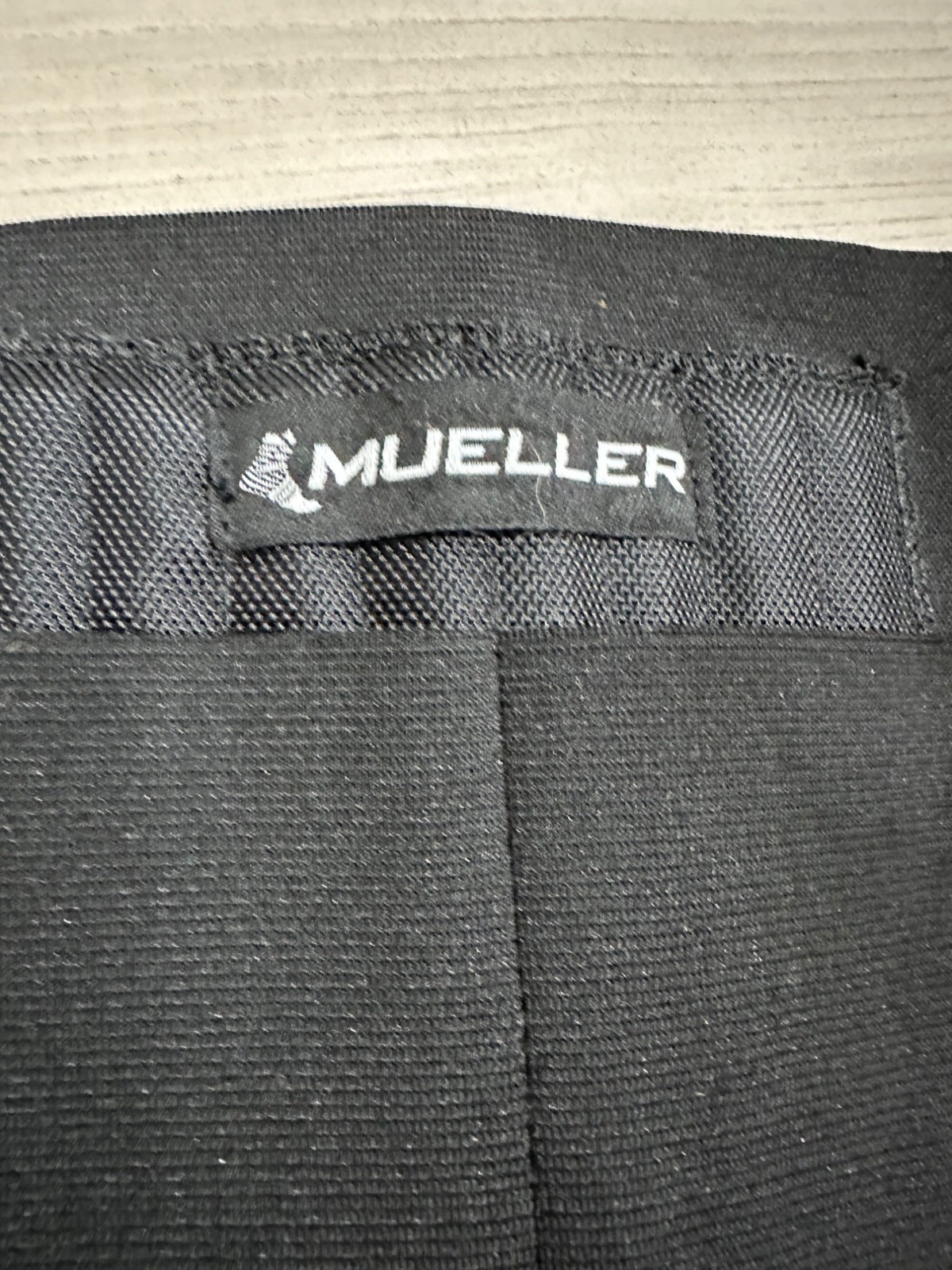 Mueller Adjustable Black Back Support Brace With Hook and Loop Closure