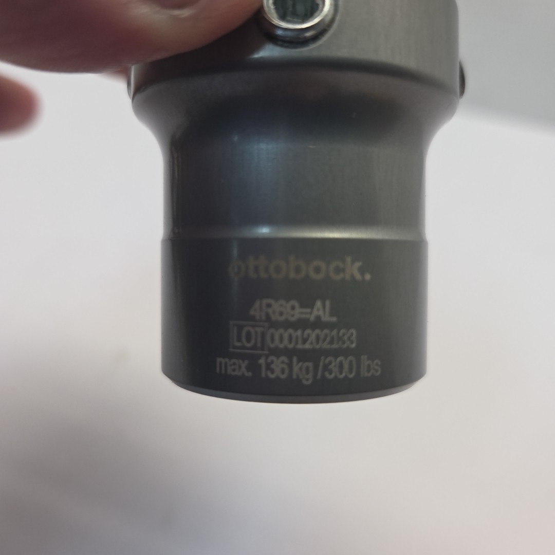 Prosthetic component adapter part. Otto Bock 4R69=AL prosthetic tube clamp.